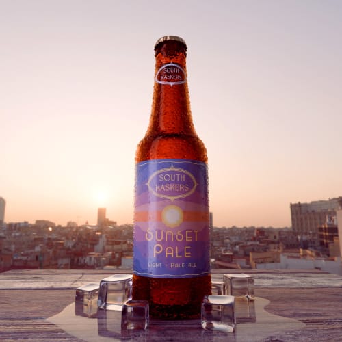 South Kaskers label design and 3D product render of a glass bottle at sunset.